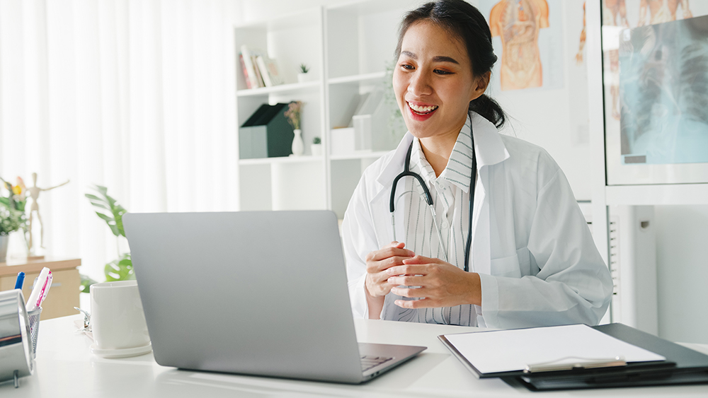 image of doctor working on a computer