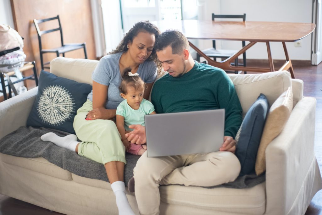 image of a family looking at a laptop together