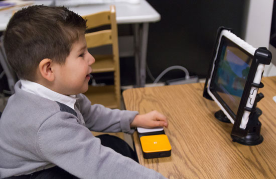 image of a child looking at a computer monitor